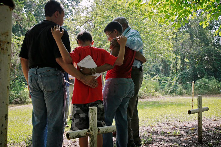 group of four in a family embrace