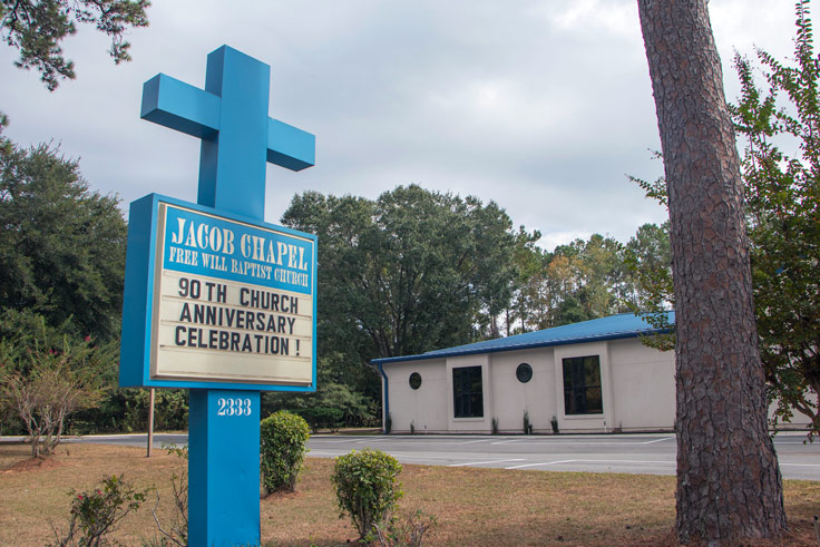 church sign and building behind it