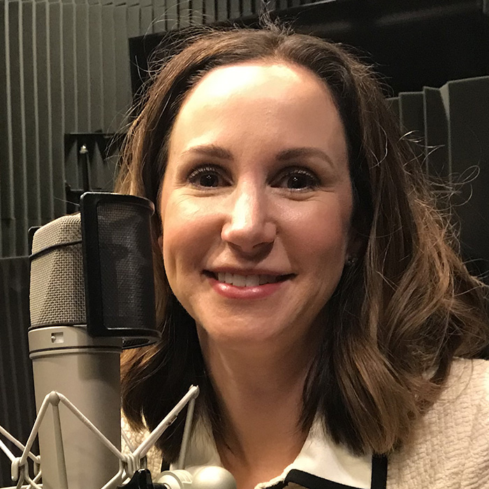 Amy Hecht at WFSU wearing headphones in the radio studio