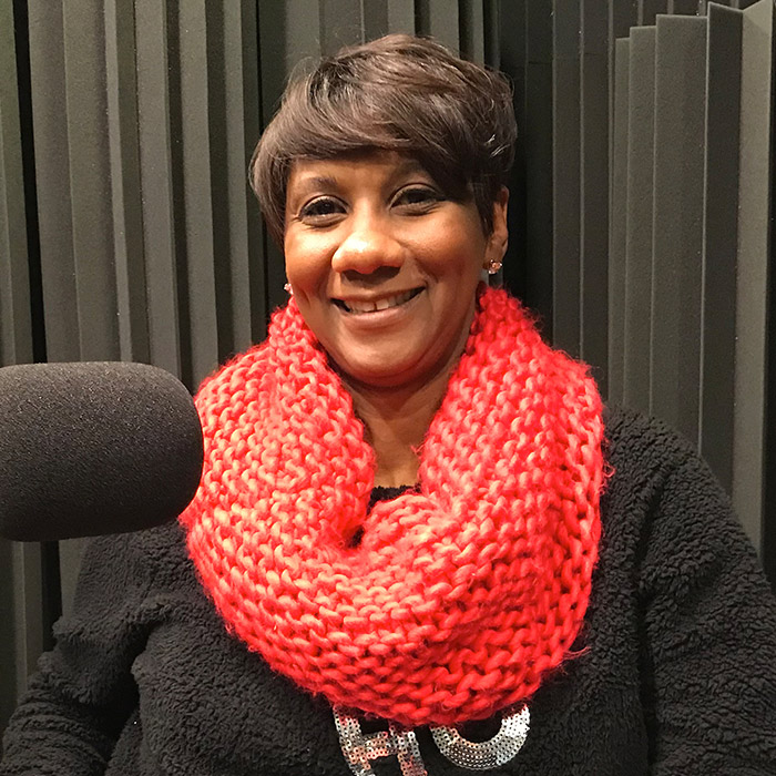 Heidi Otway sitting in WFSU's radio studio in front of the mic