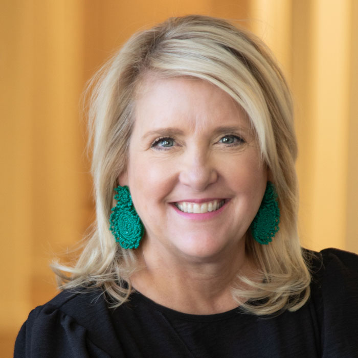 blonde woman with earrings smiling