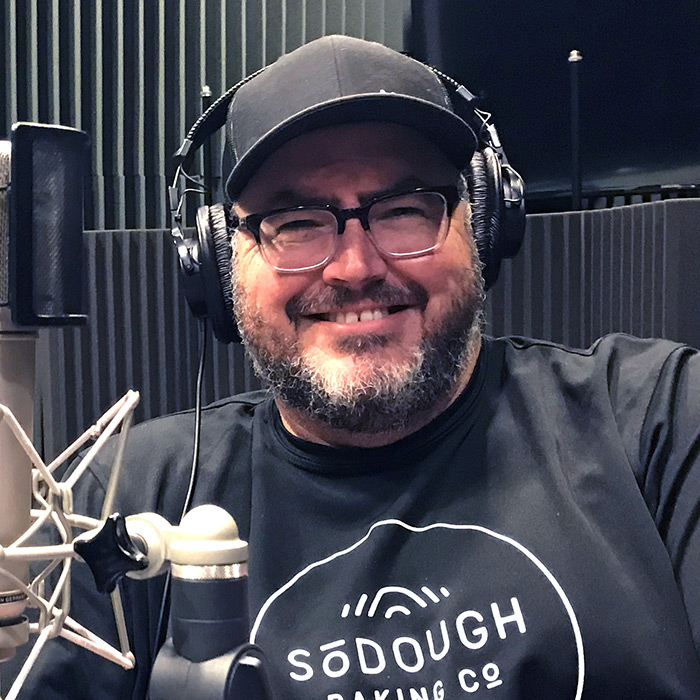 Matt Thompson in sitting front of the microphone