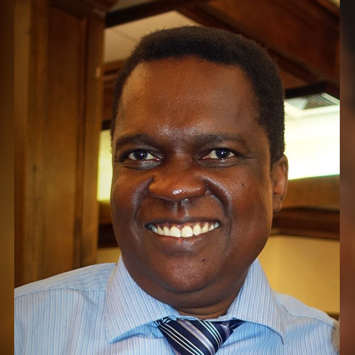 African man smiling in shirt and tie