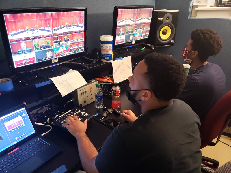 2 male students working on the switcher during a tv production