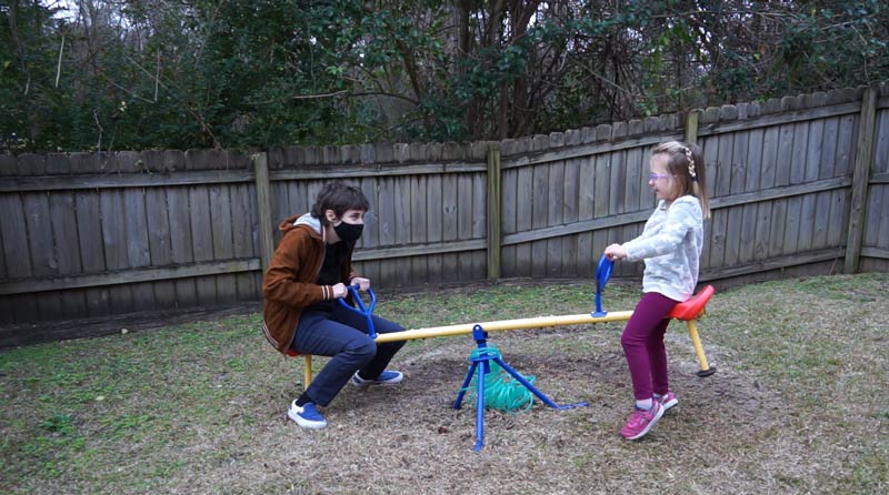 Robbie and Isabelle on a seesaw 