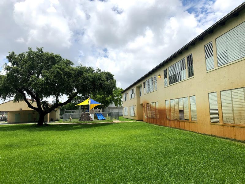 mid-century building exterior with playground